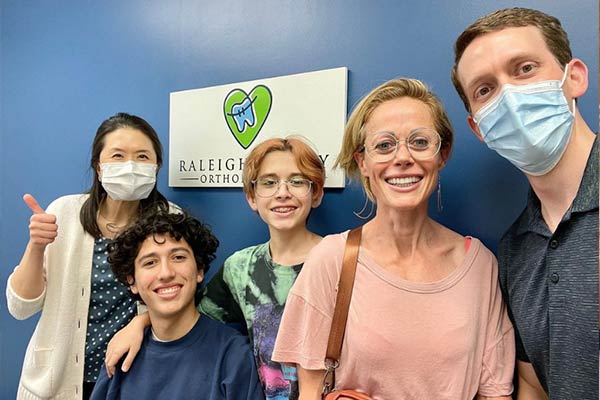 Dr. Lee and Dr. Neill with their patient and family at Raleigh Family Orthodontics 